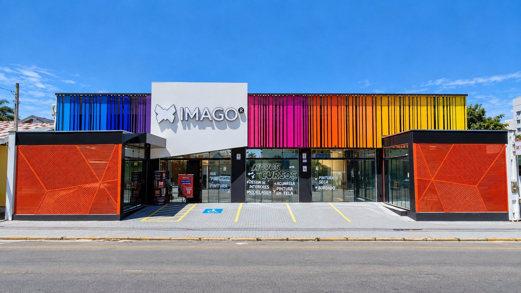 Fachada da Imago com ripado em ACM nas cores azul, magenta, laranja e amarelo, painéis laranja vazados e letreiro Imago